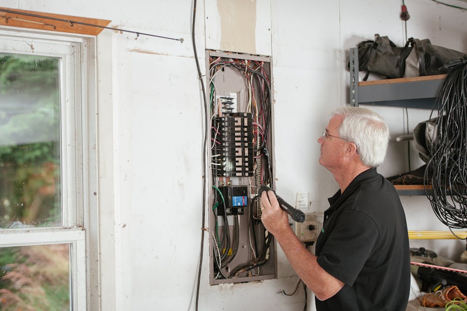Professional electrician working on electrical panel upgrade with safety equipment and modern home interior